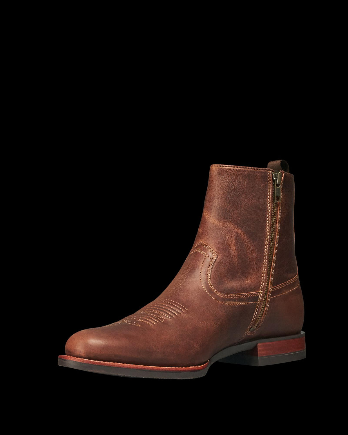 The Wayne in Maplewood Cowhide. Brown leather ankle boot with side zipper, low stacked heel, and decorative stitching on the upper, crafted from The Wayne Cowhide, displayed on a white background.