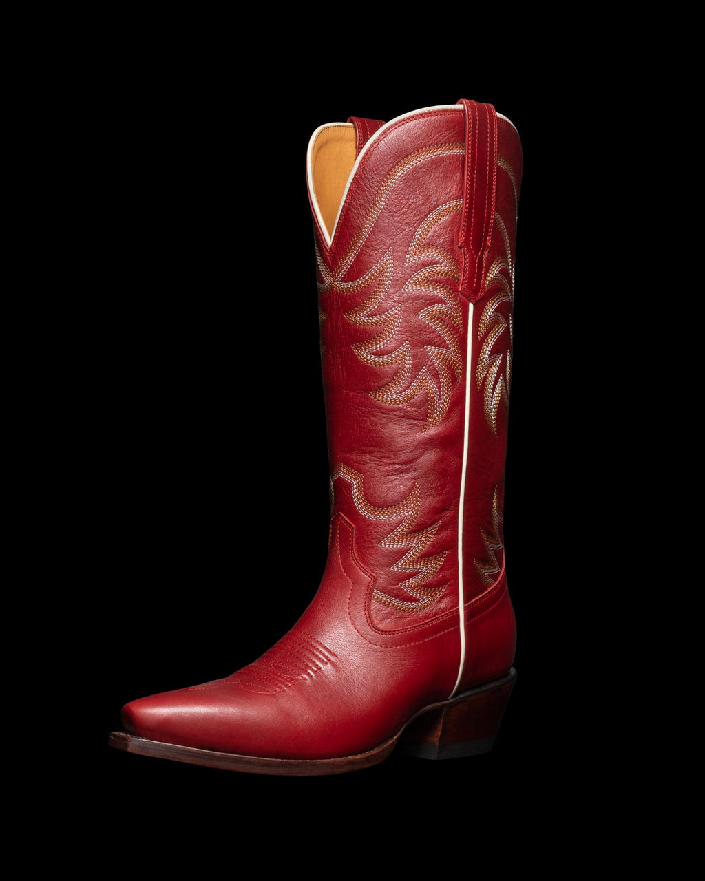 Red cowboy boot with decorative stitching, angled view.