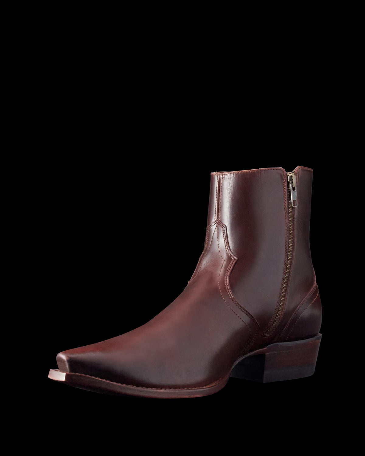A brown leather ankle boot with a pointed toe and stacked heel. It features side stitching and a zipper on the side.