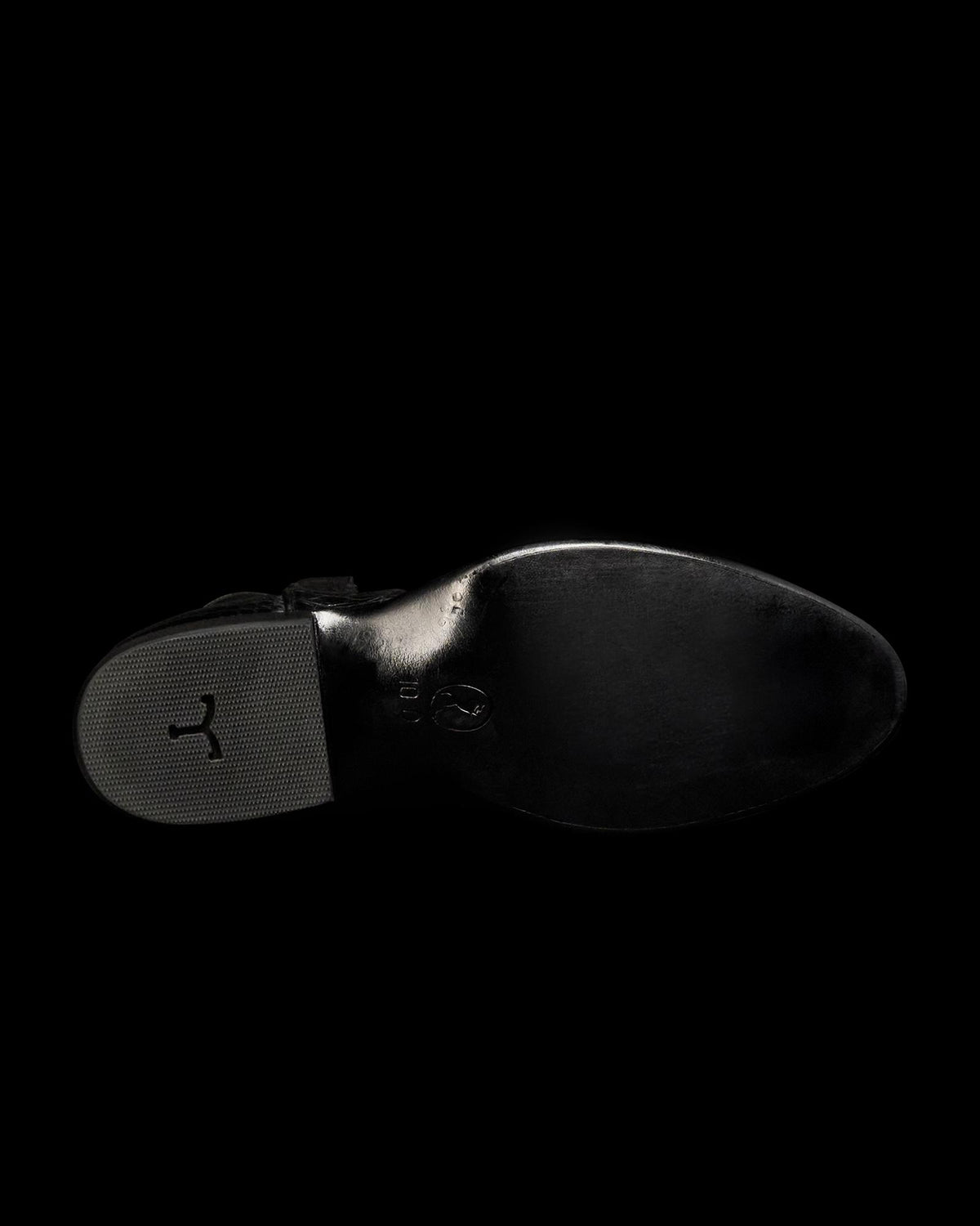 Sole view of The Stallion x Tecovas Boot - Midnight Giant Gator on plain background