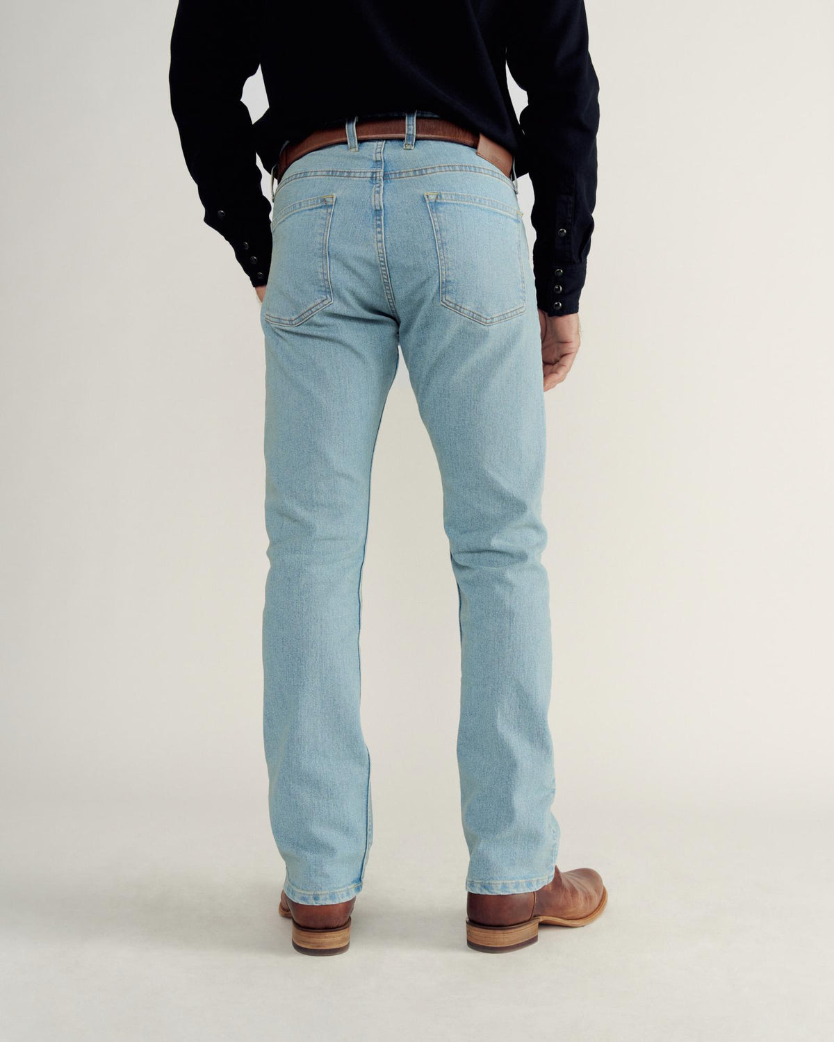 Back view of Men's Slim Straight Stretch Denim - Light Stone Wash on model