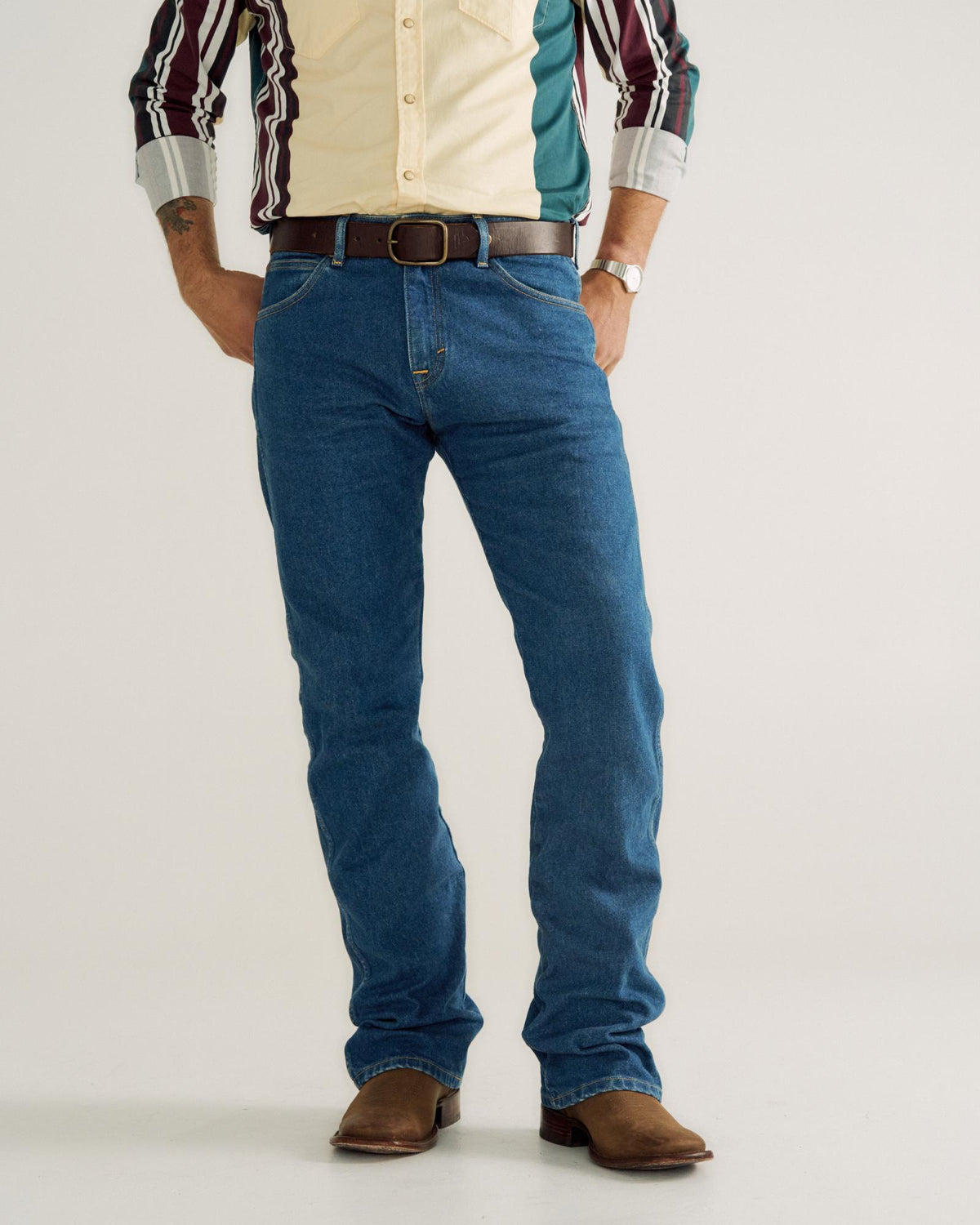 Front view of Men's Modern Bootcut Heritage Denim - Medium Blue on model