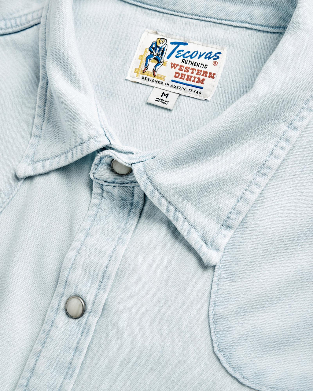 Closeup detail view of Men's Denim Short Sleeve Pearl Snap - Ultra Light