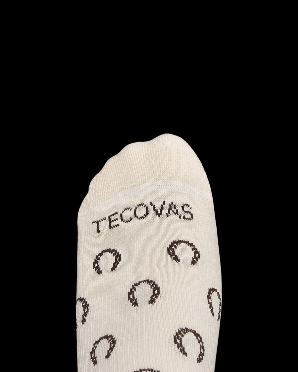 Cream-colored sock with the word "TECOVAS" and brown horseshoe patterns, shown on a white background.