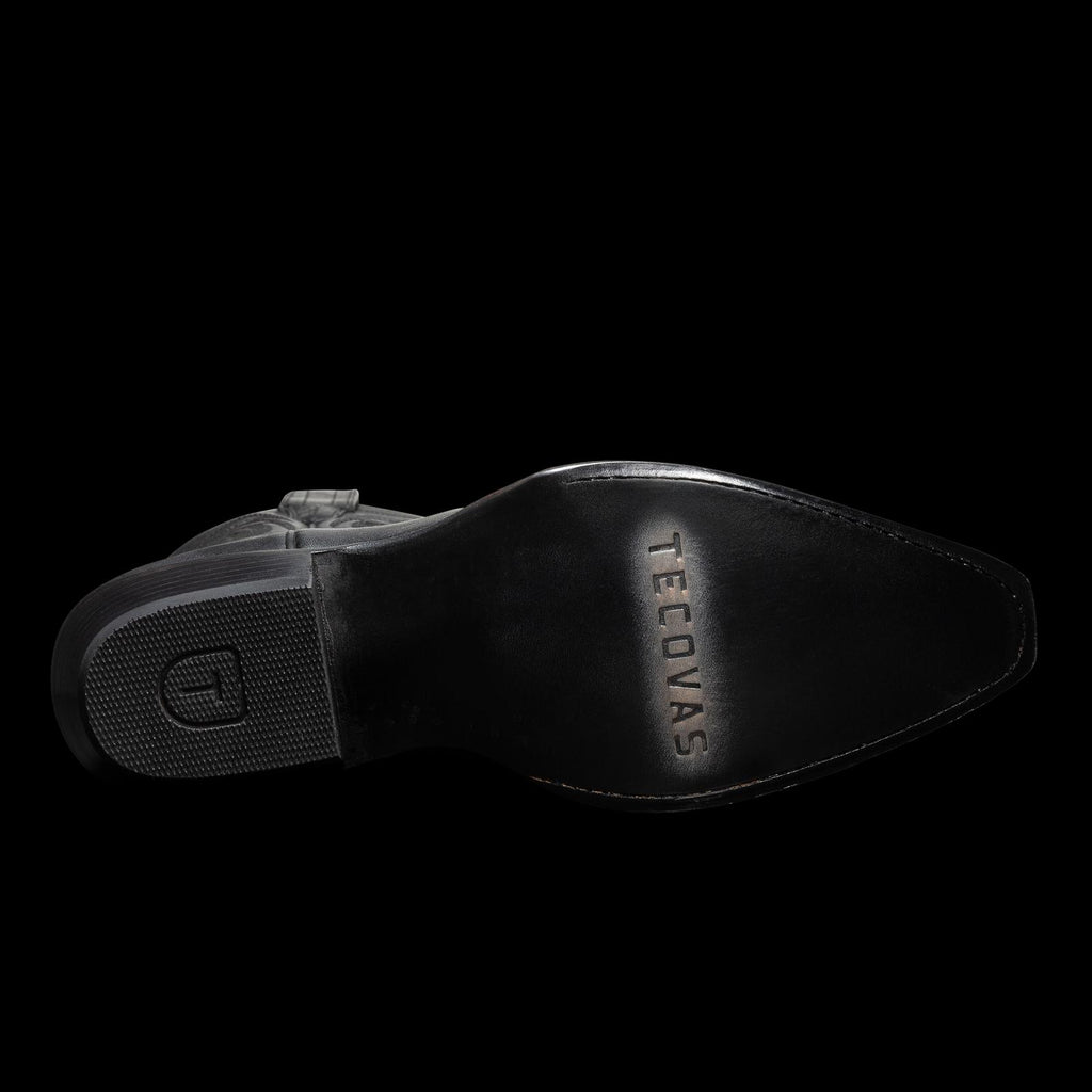 Sole of a black leather boot with "TECOVAS" engraved, featuring textured and smooth sections.