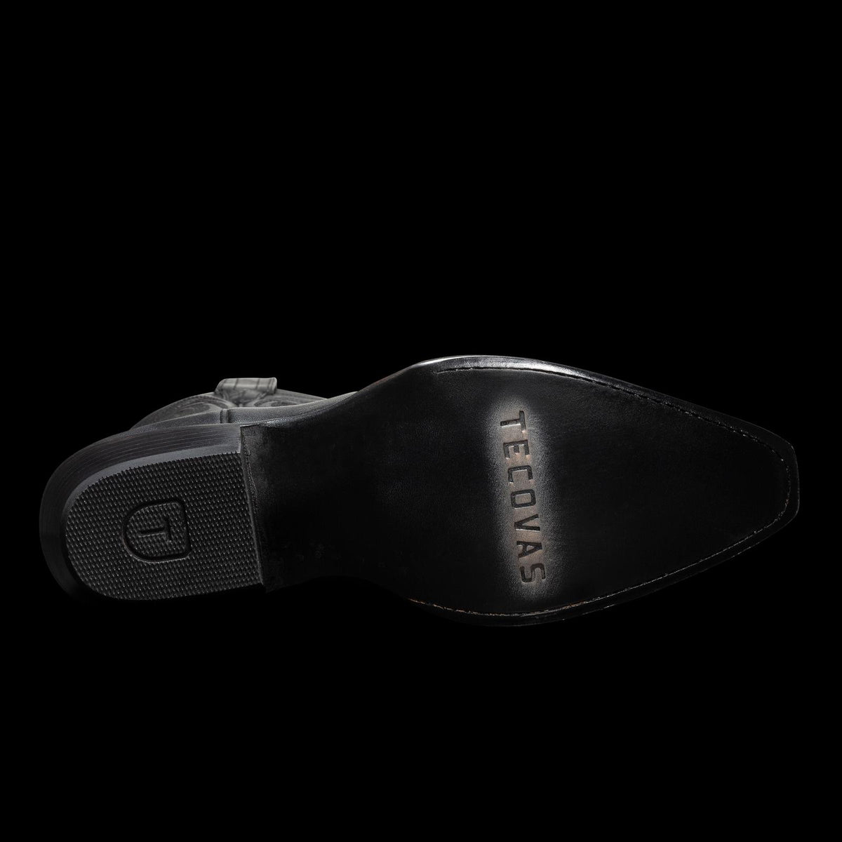 Sole of a black leather boot with "TECOVAS" engraved, featuring textured and smooth sections.