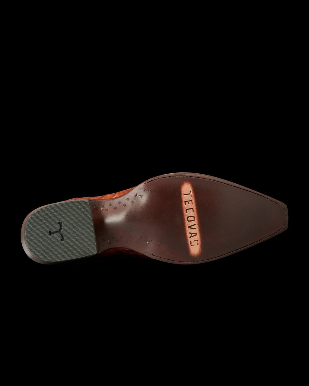 The underside of a brown leather dress shoe with “Tecovas” engraved on the sole and a textured rubber heel pad, crafted in the refined style of The Garrett Hornback Caiman in rich Pecan.