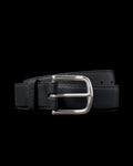 A black leather belt with a shiny silver buckle, coiled neatly against a plain black background.