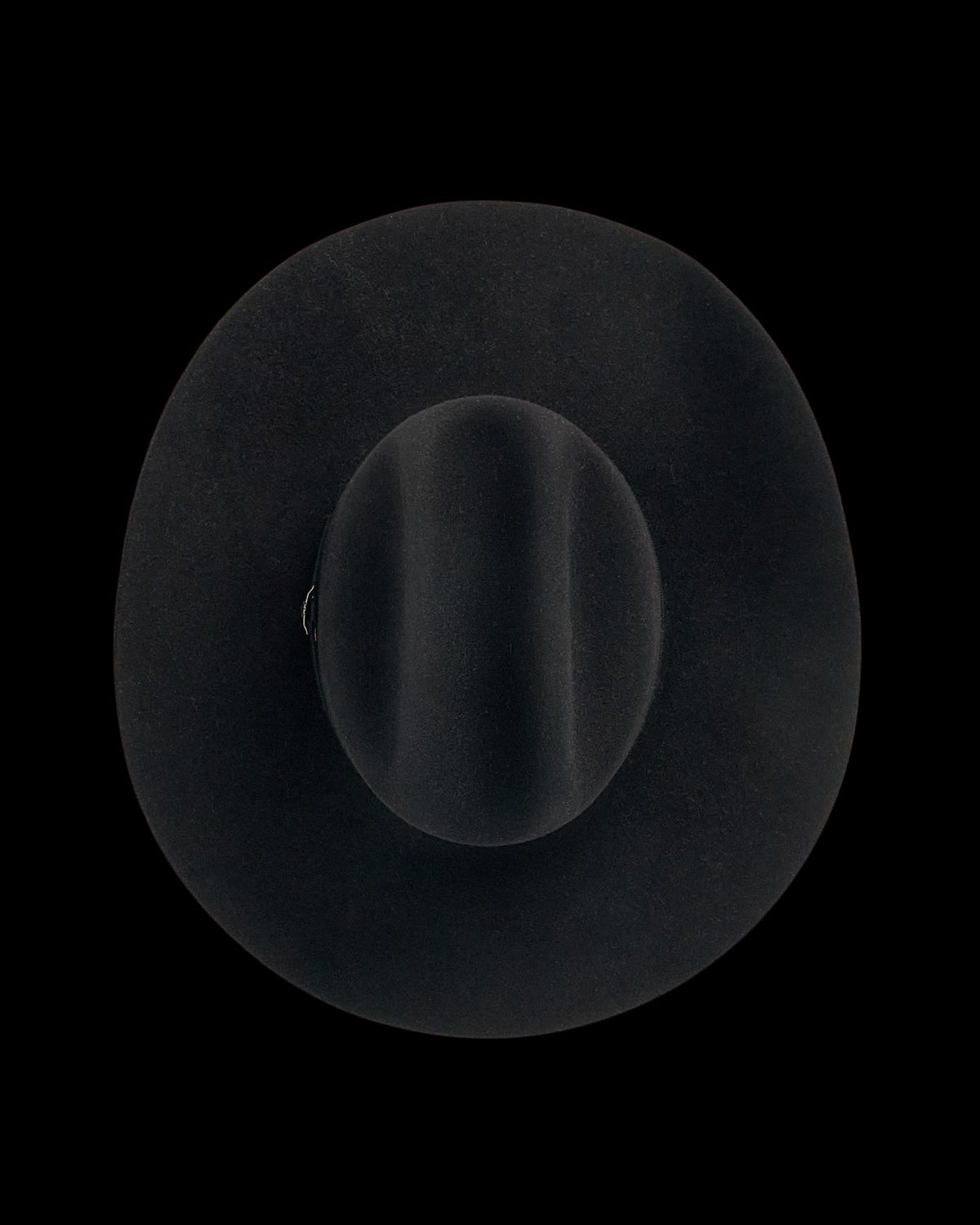 A wide-brimmed black felt hat is shown photographed from above on a plain white background.