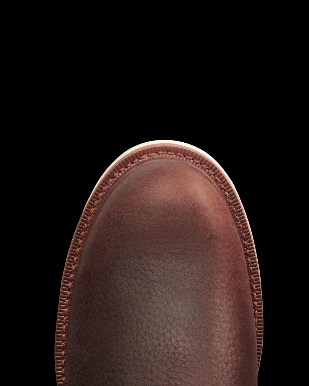 The Knox Lace Up in Cognac Cowhide. Close-up of the toe of a Cognac cowhide Knox Lace Up boot with a white sole.