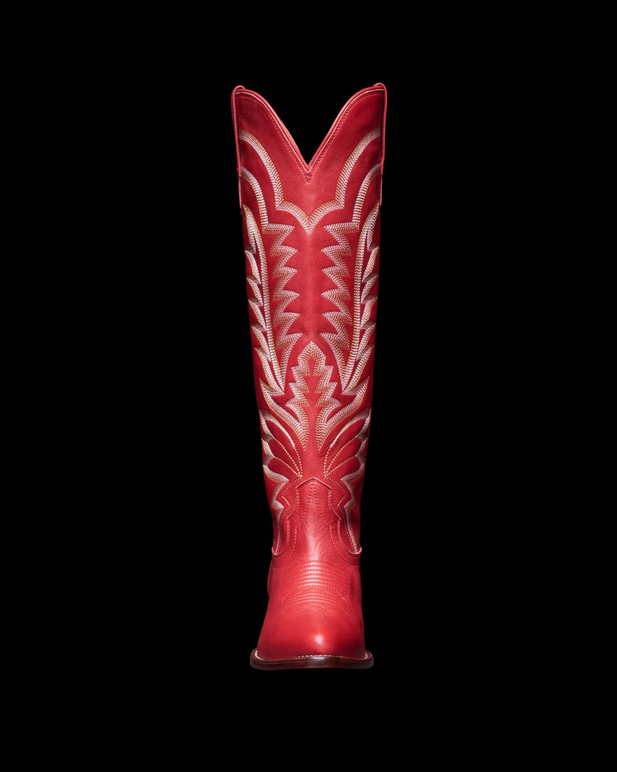 Front view of The Abby Wide Calf Cowhide boot in crimson red leather, featuring decorative white stitching on a plain white background.