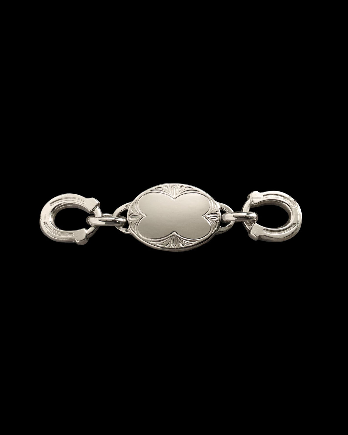 Silver oval jewelry clasp with engraved edges and two circular fasteners on each end, displayed on a plain white background.