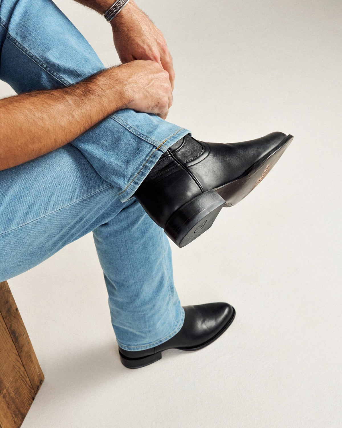 close up picture of Earl midnight black cowboy boots on a man's feet