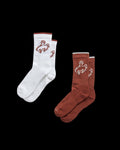 Quarterfront view of Buckin Bronc Crew Socks (2-Pack) - White / Rust on plain background