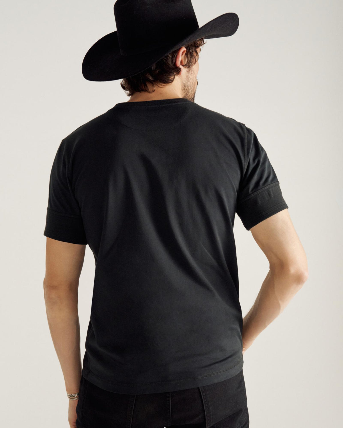 Closeup of man wearing a black henley