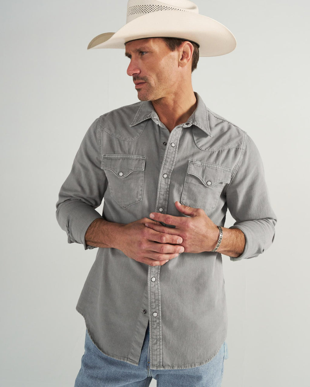 Closeup detail view of Men's Denim Pearl Snap - Light Gray