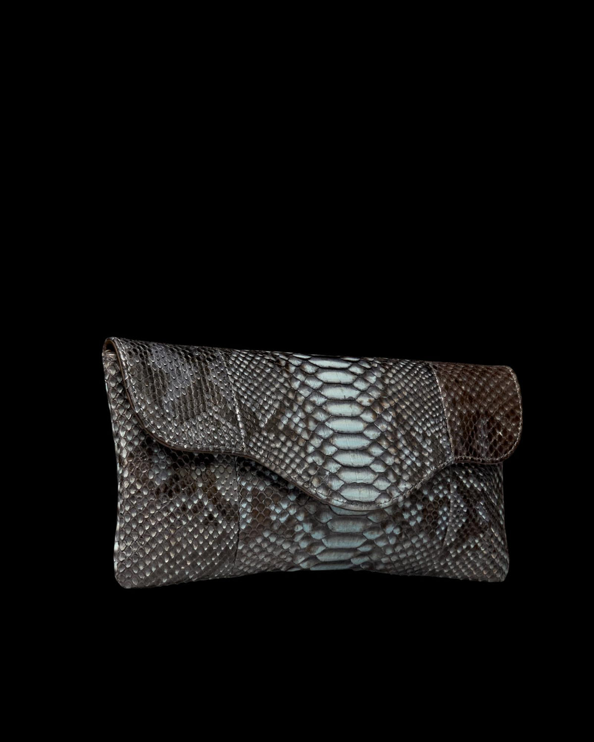 A clutch handbag made of textured material with a blue and dark brown scale pattern and a flap closure.