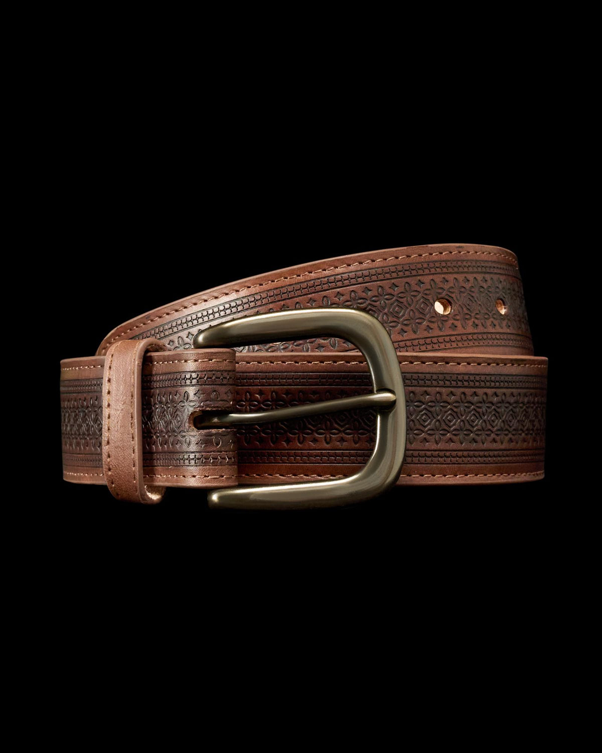 Brown leather belt with embossed pattern and brass buckle, coiled on a plain white background.