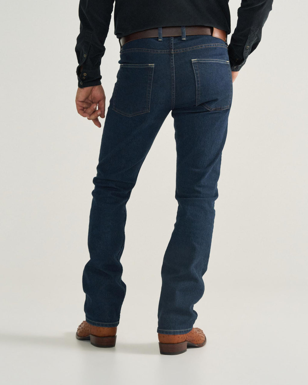 Back view of Men's Slim Straight Stretch Denim - Dark Indigo on model
