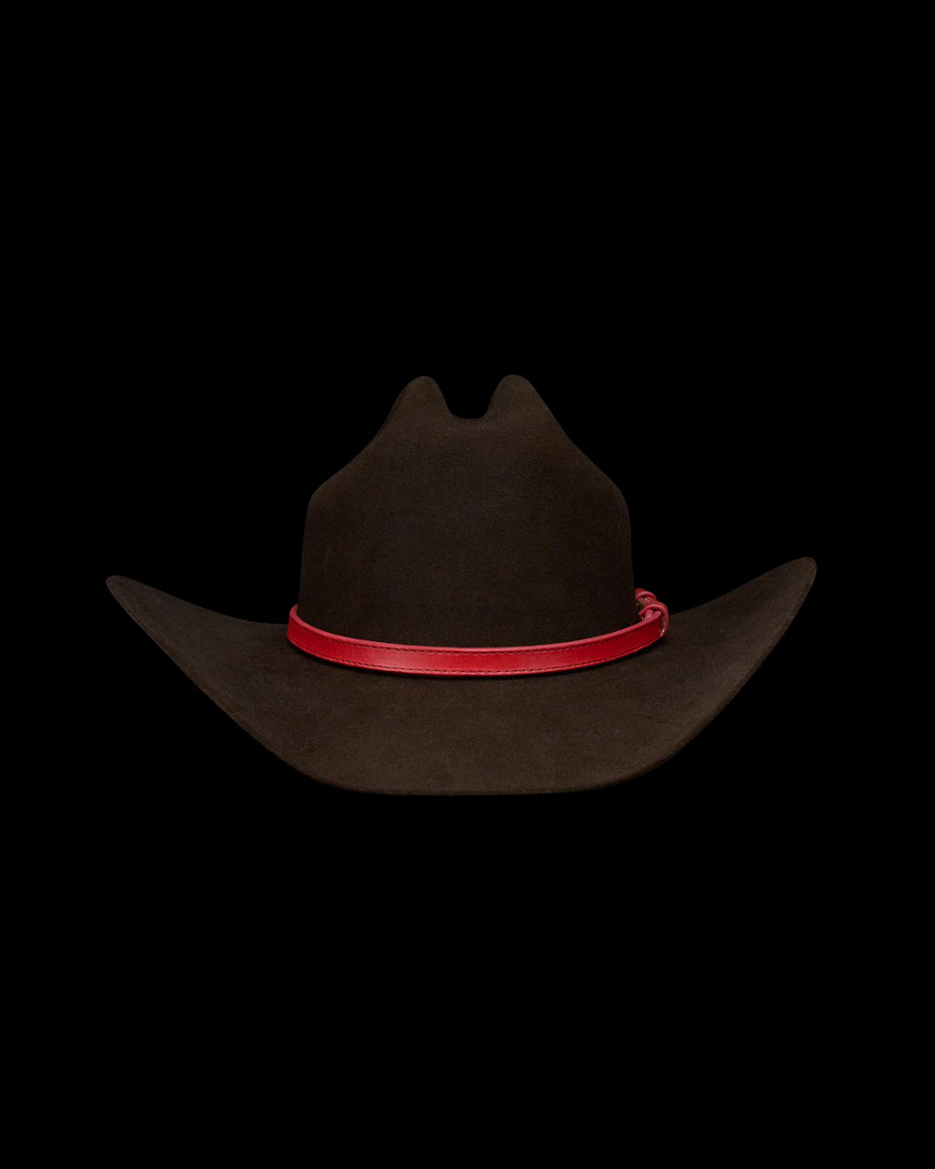 A dark brown cowboy hat with a curved brim and a red band around the base of the crown, displayed on a white background.