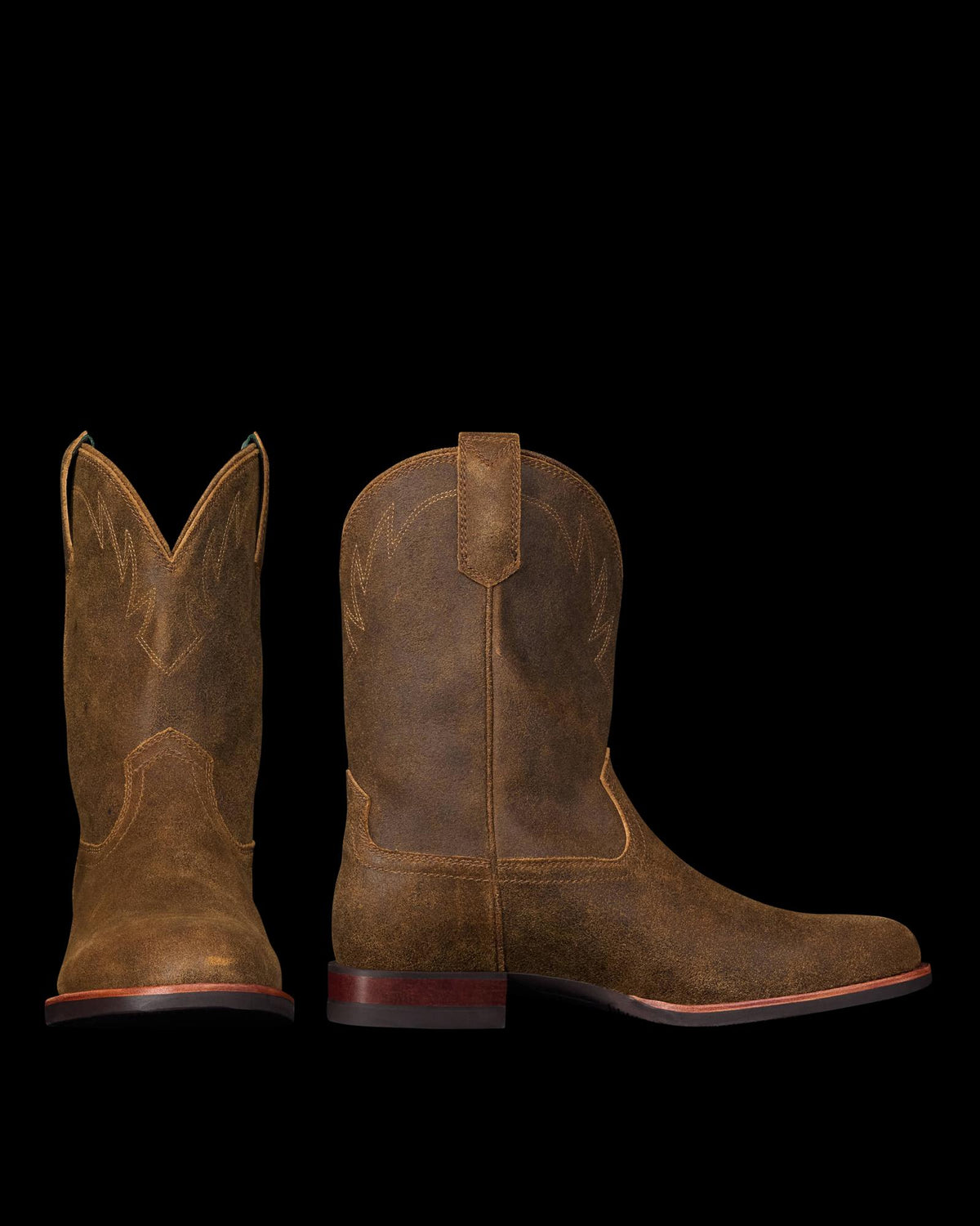 The Glen in Dustwood Roughout. A pair of brown leather Roughout cowboy boots with stitching detail, shown from the front and side on a white background.