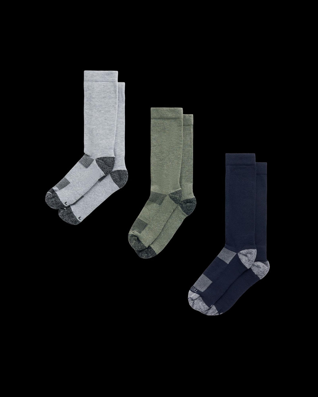 Three pairs of crew socks in light gray, olive green, and navy blue, each with dark gray accents on the toe and heel, displayed against a white background.