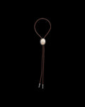 Front view of Iron Lamb Fossilized Coral Bolo - Cream / Black on plain background