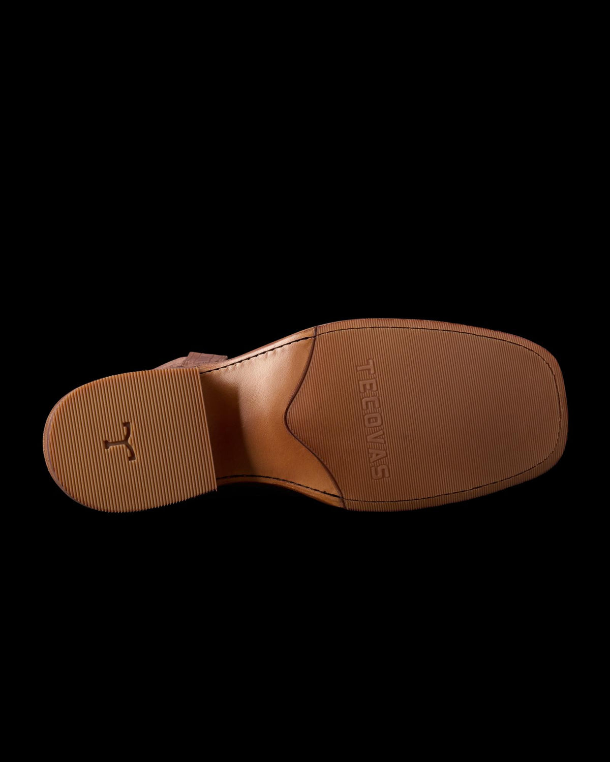 Bottom view of a brown leather shoe sole with textured grip and the brand name "Meermin" embossed.