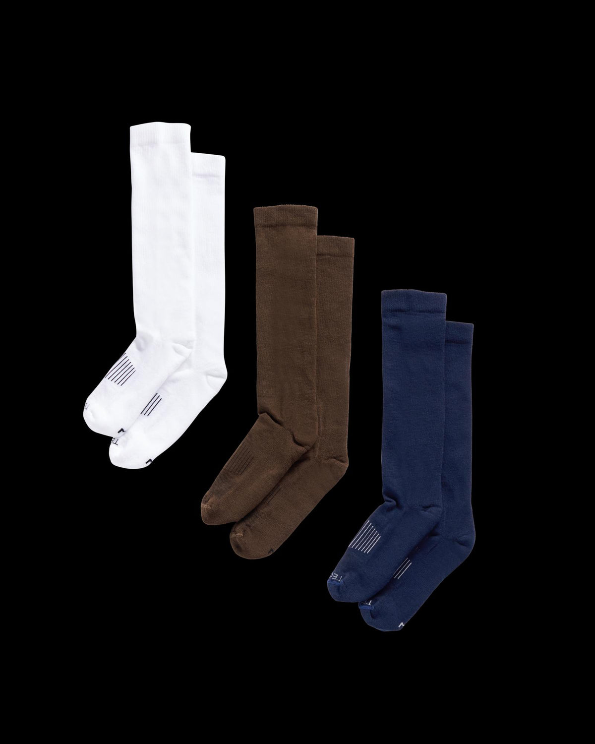 Quarterfront view of Boot Socks - Navy / Brown / White on plain background