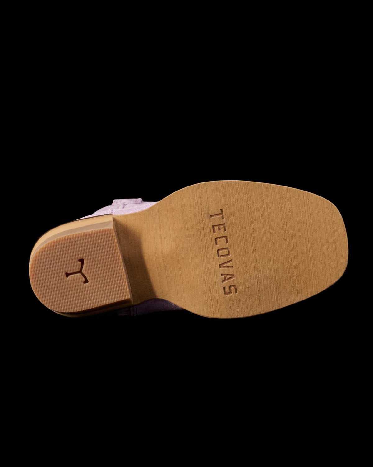 The sole of a boot with "Tecovas" stamped on the bottom; heel features a horseshoe-shaped detail.