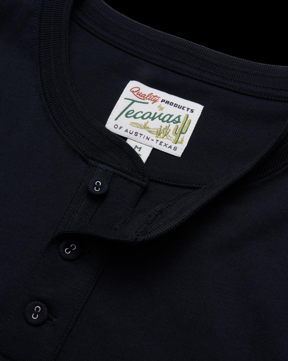 closeup of the men's black short sleeve henley