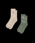 Two pairs of crew socks, one beige and one green, each with a small embroidered logo near the top.