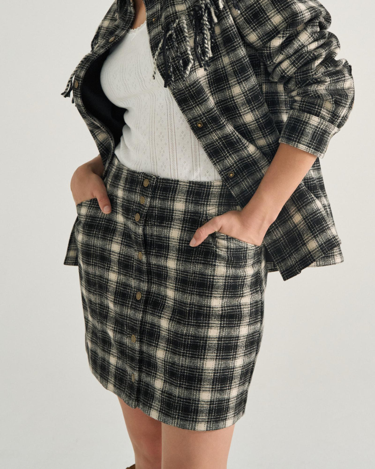 Front view of Women's Plaid Mini Skirt - Black / White on model