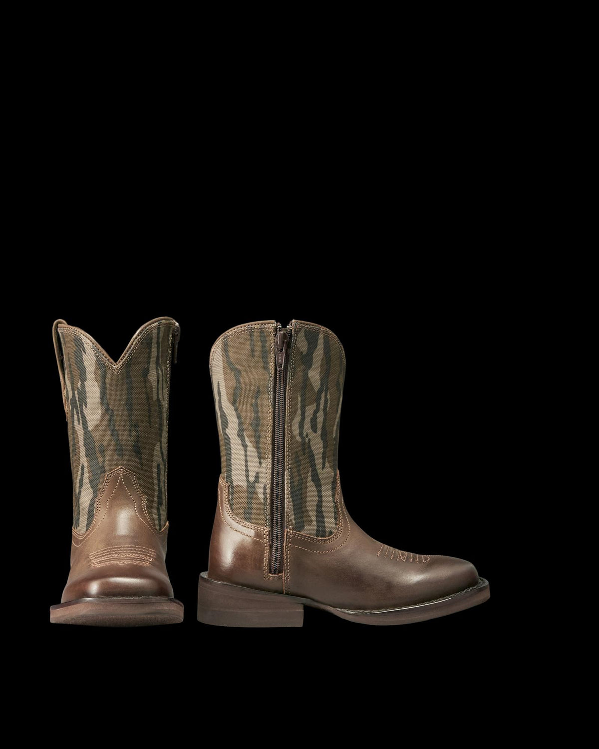 Pair of brown leather cowboy boots with camouflage-patterned fabric shafts and side zippers, displayed against a plain white background.