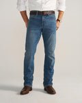 Front view of Men's Slim Straight Stretch Denim - Medium Indigo on model