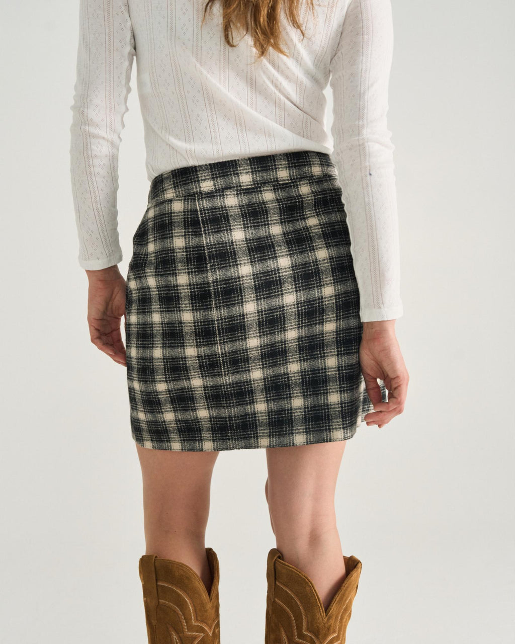 Back view of Women's Plaid Mini Skirt - Black / White on model