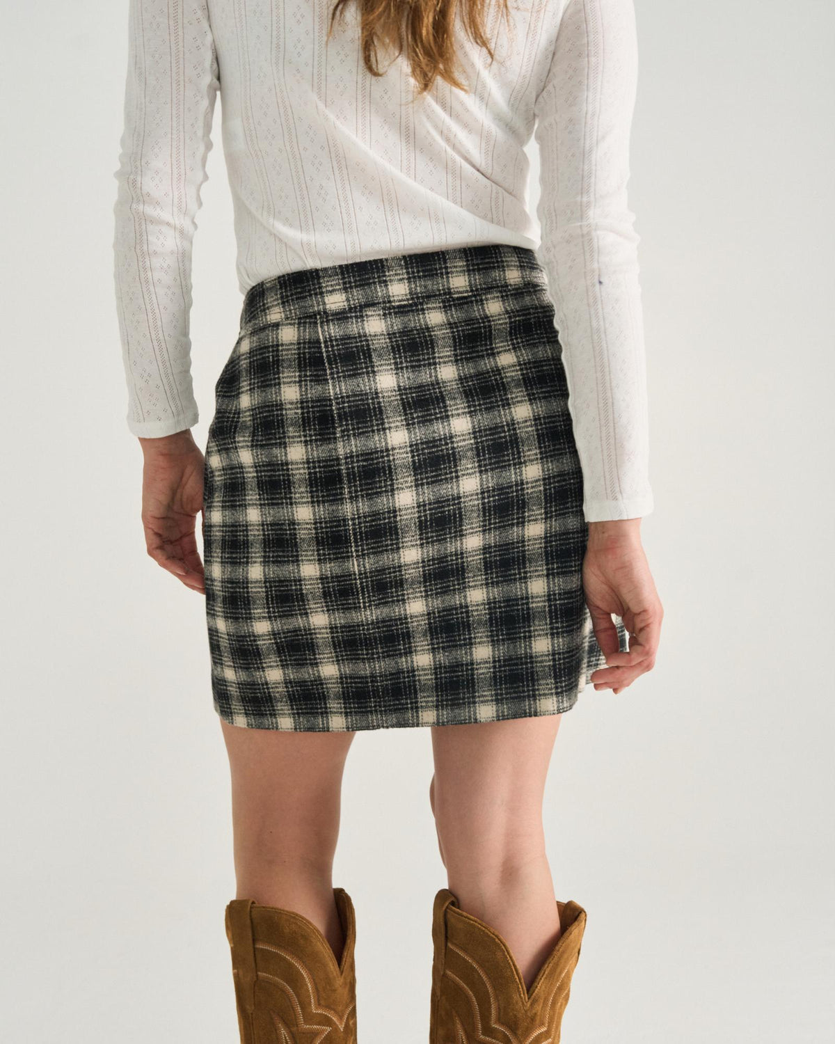 Back view of Women's Plaid Mini Skirt - Black / White on model