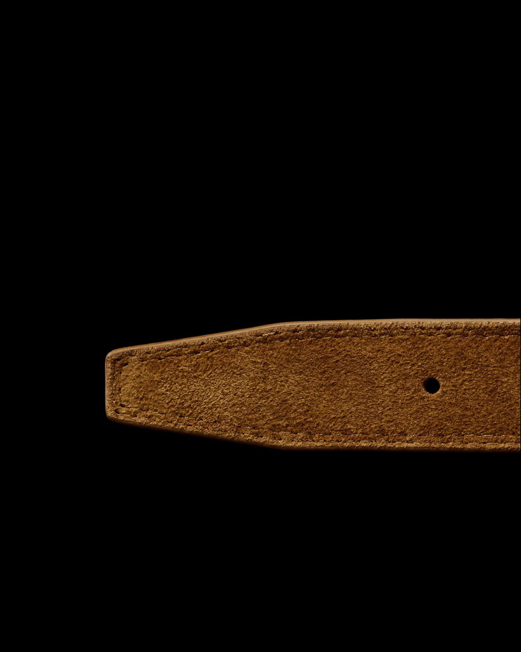 Close-up of the end of a brown suede belt with a pointed tip and a single punched hole, displayed on a white background.