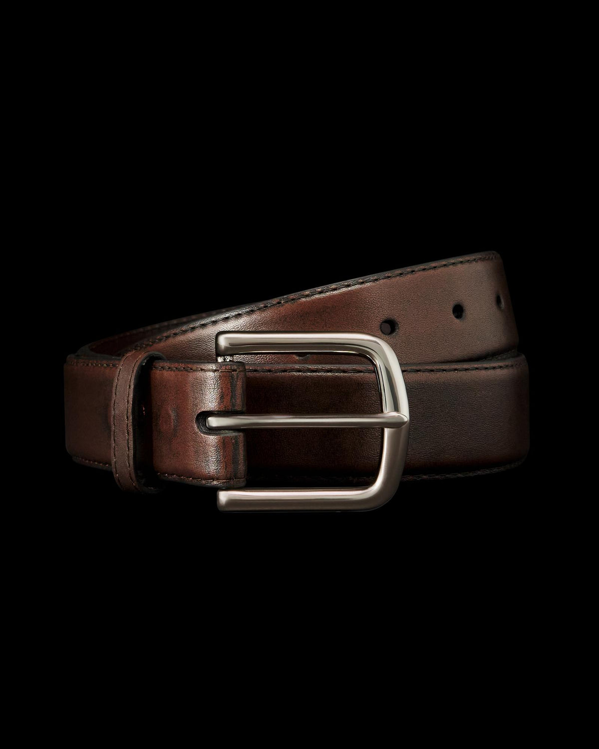 A brown leather belt with a silver rectangular buckle, placed on a plain white background.