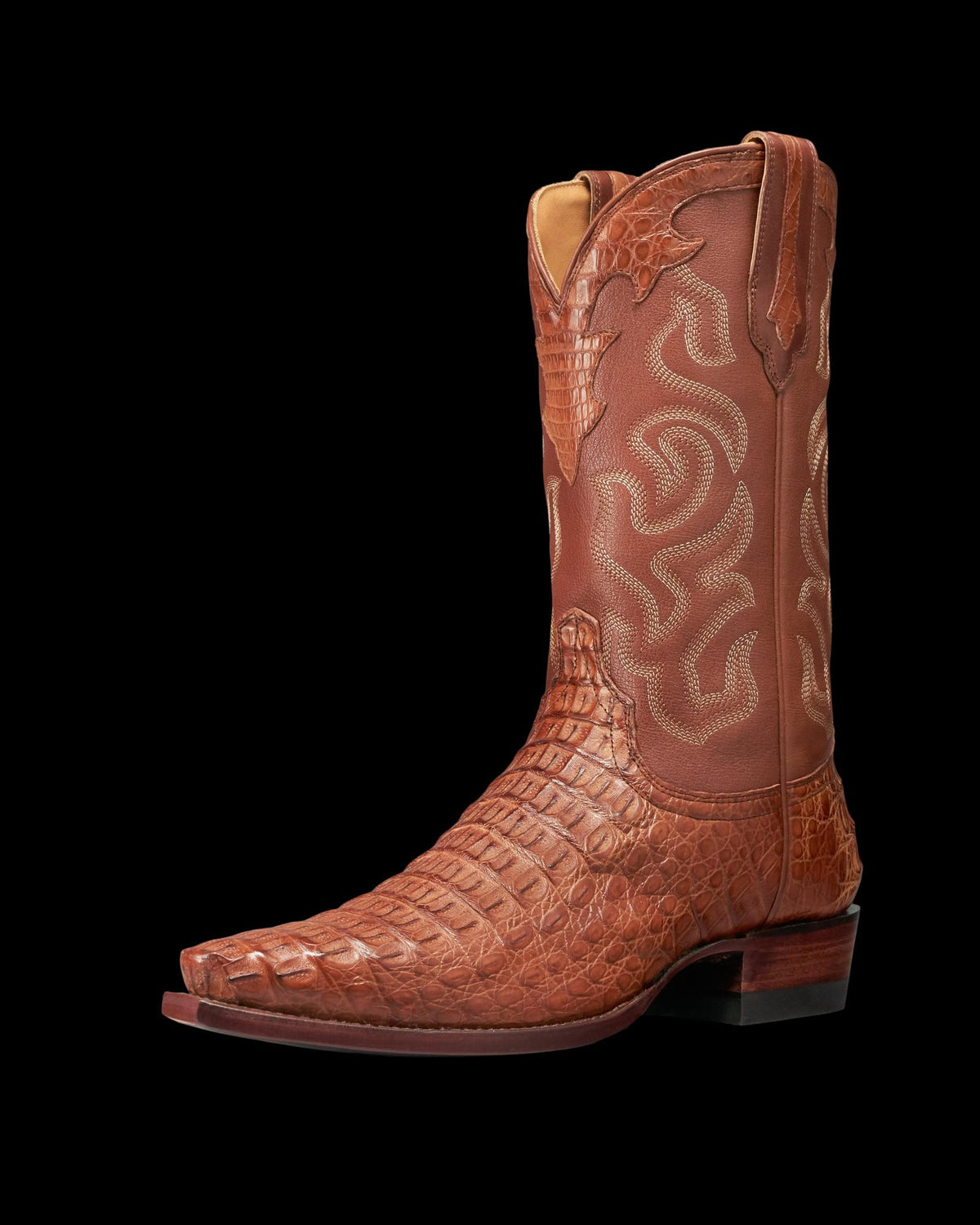 The Garrett Hornback Caiman brown cowboy boot features textured, crocodile-patterned leather on the foot and decorative stitching on the shaft, showcasing a pointed toe and stacked heel in rich Pecan Hornback Caiman.