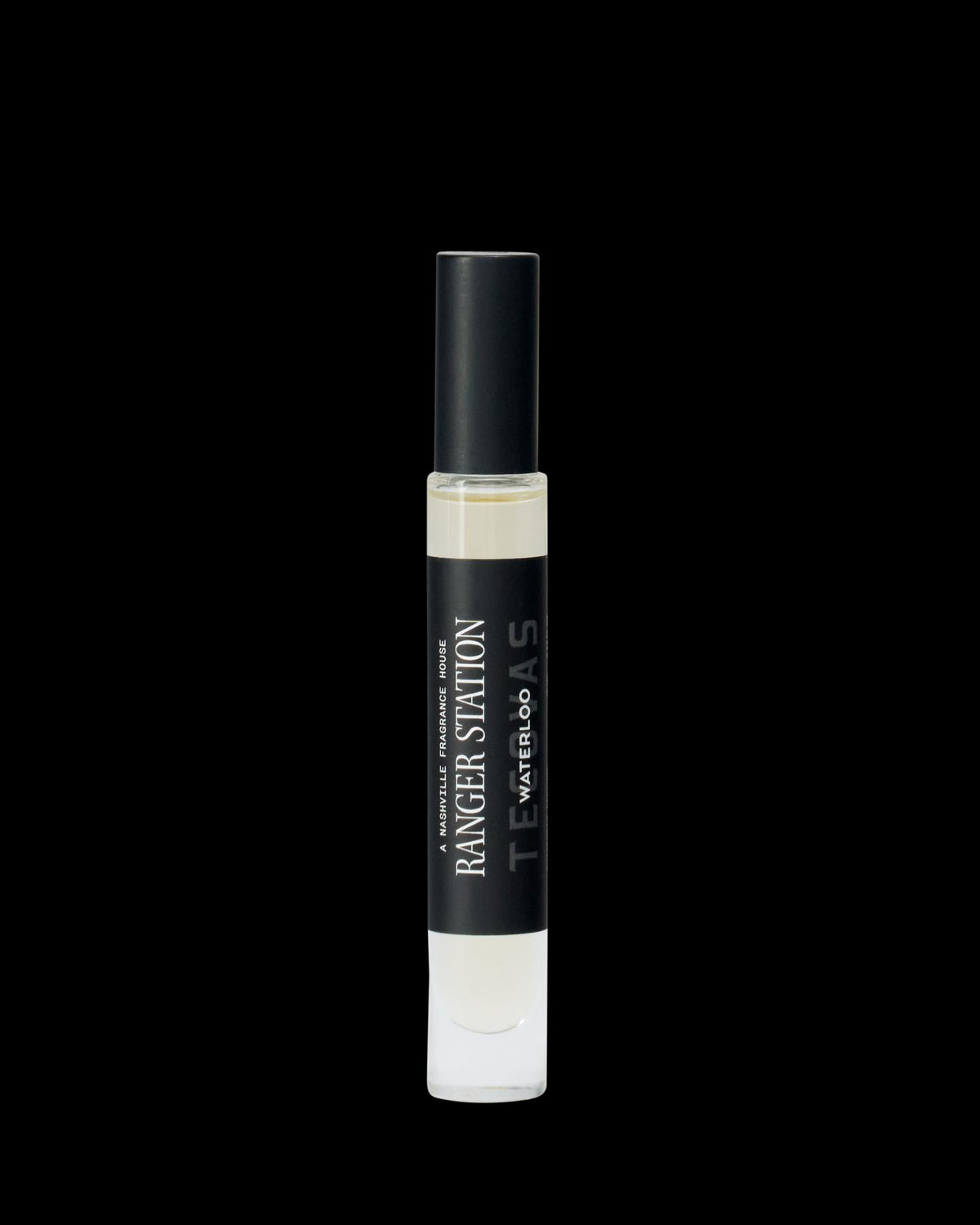 A clear glass perfume spray bottle labeled "Ranger Station Teakwood & Water" with a black cap, shown on a plain white background.