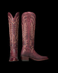 The Abby in Wine Goat. A pair of tall, burgundy leather cowboy boots from The Abby Goat, featuring decorative stitching and pointed toes, shown side by side on a white background.