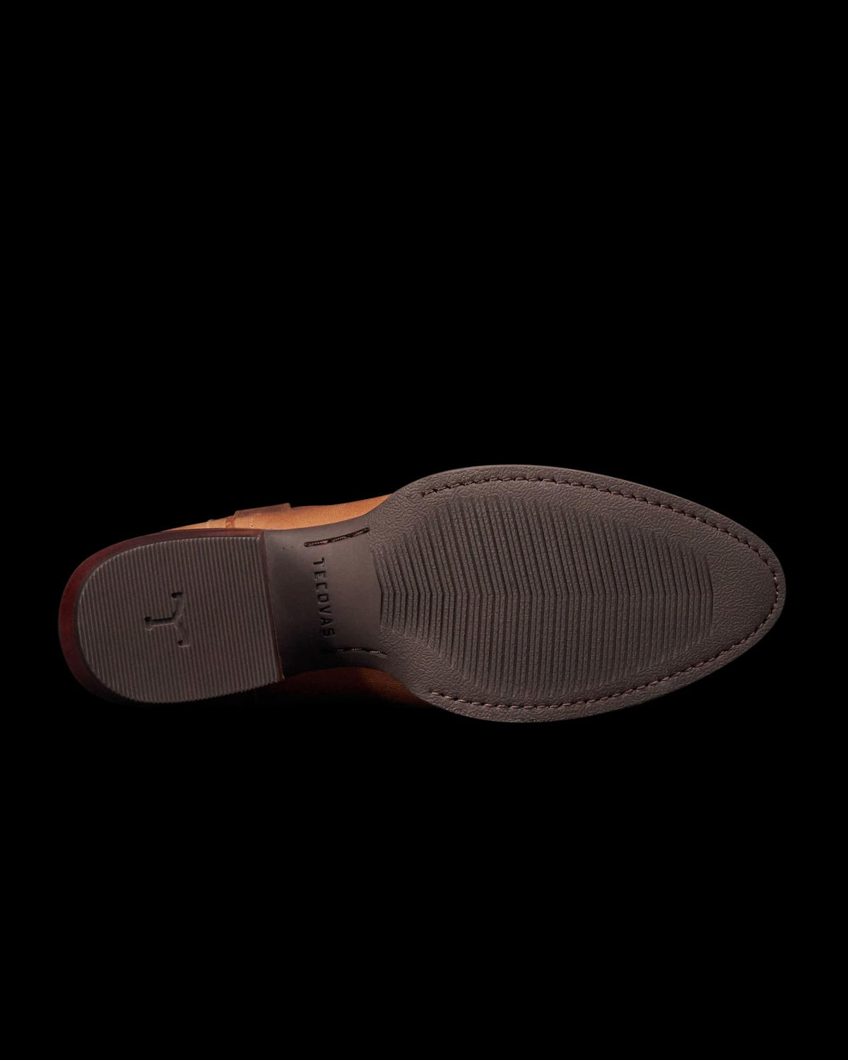 The Britt in Latte Goat. Brown leather dress shoe shown from the bottom, displaying a textured rubber sole with a small emblem and the word "FLORENTINI" embossed near the center—a refined style inspired by The Britt Goat collection.