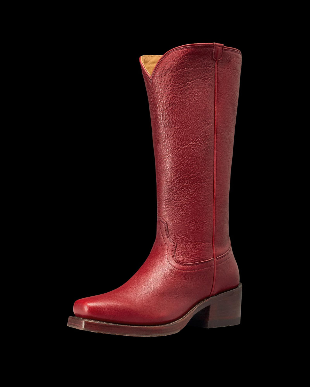 The Charlie in Scarlet Cowhide. A single tall scarlet cowhide leather cowboy boot with a pointed toe, mid-height heel, and decorative stitching, photographed on a white background.