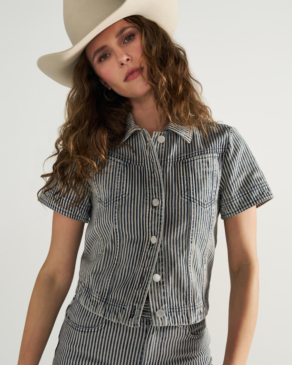 Front view of Women's S/S Denim Top - Blue / White on model