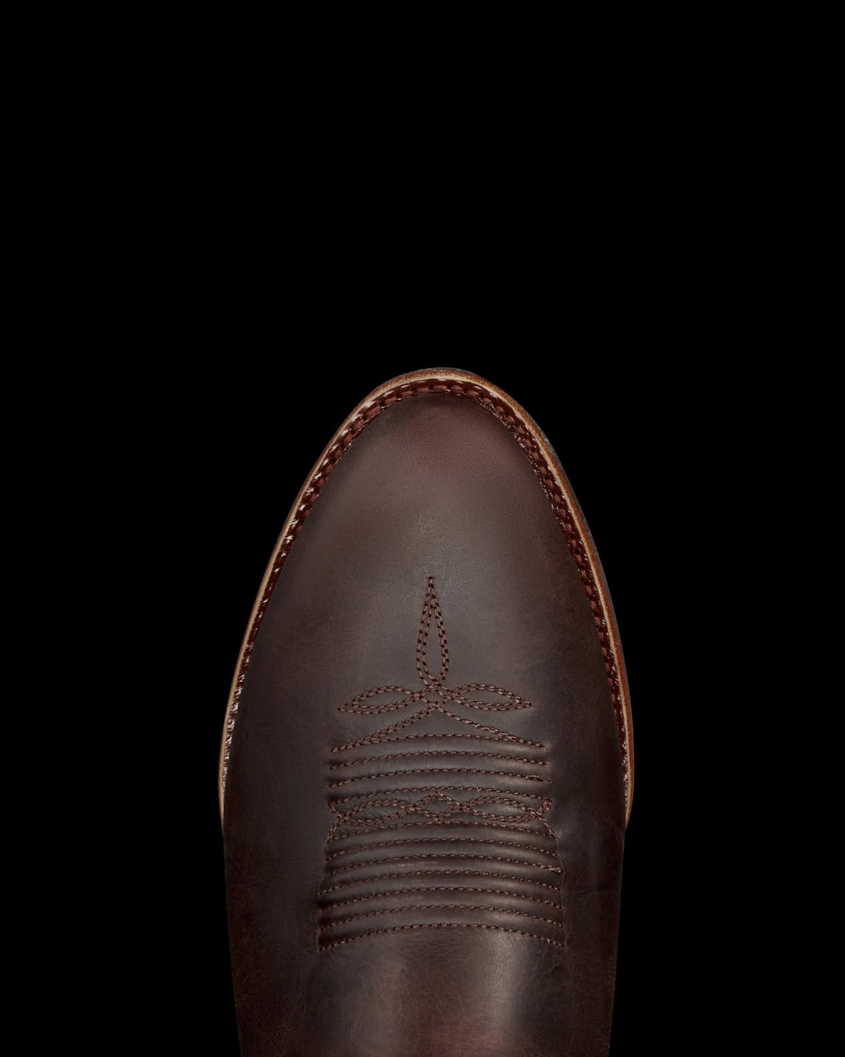 Toe view of The Buck - Molasses Cowhide on plain background