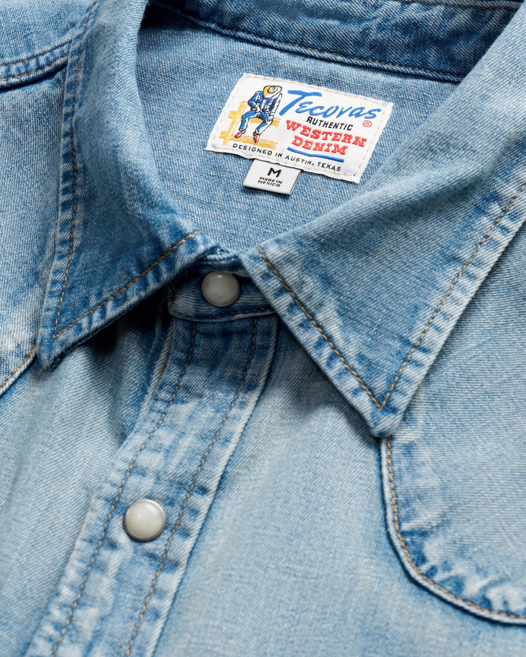 Closeup detail view of Men's Denim Pearl Snap LS - Light Wash