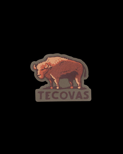 A die-cut sticker featuring a brown bison above the word “TECOVAS” in brown lettering.