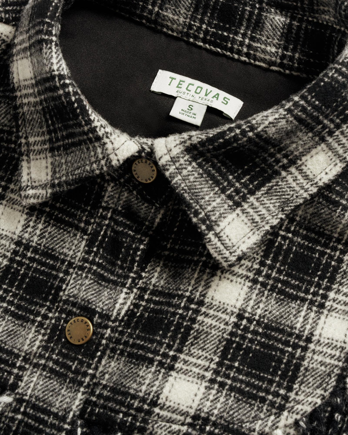 Closeup detail view of Women's Plaid Fringe Shacket - Black / White