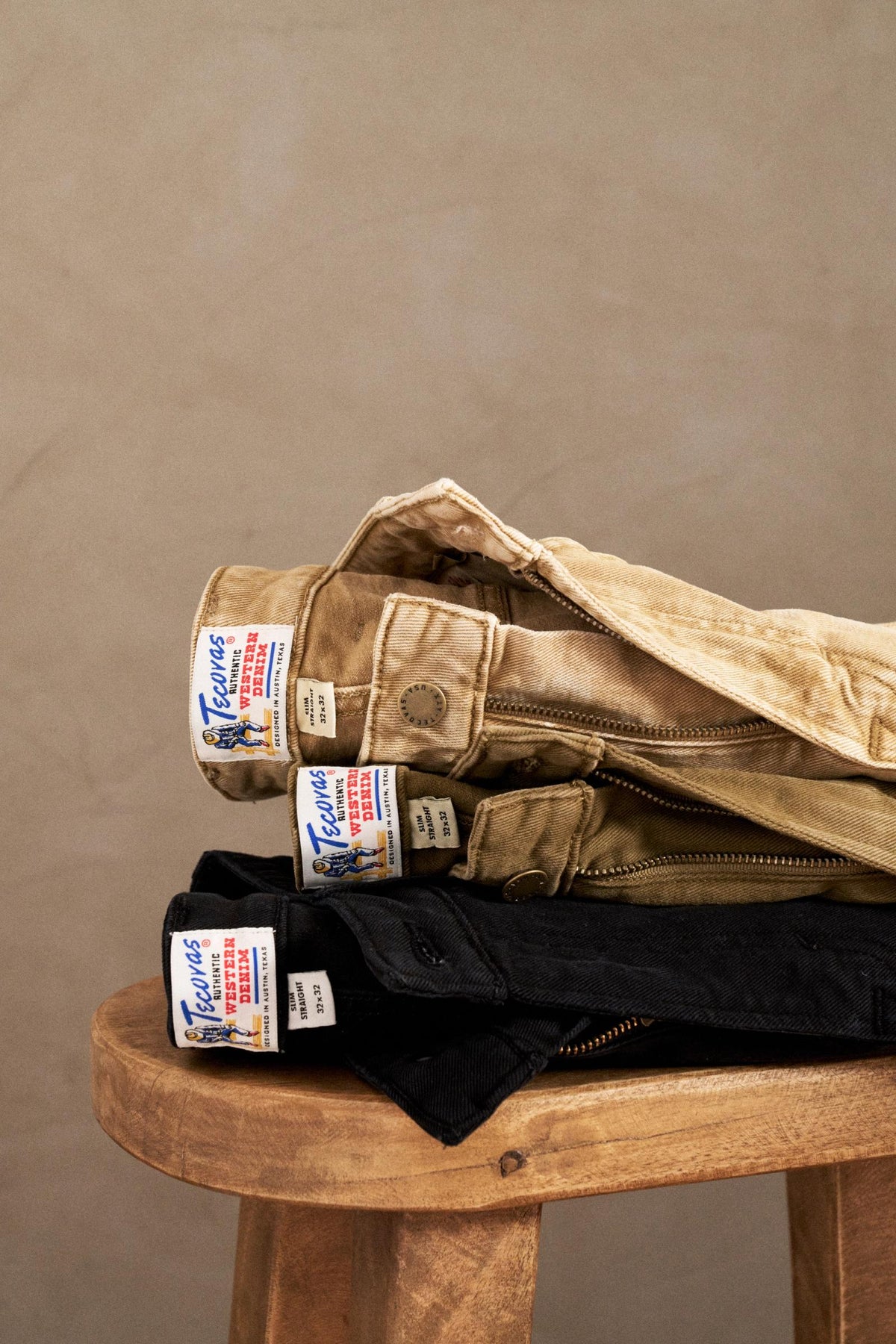 A stack of pants on a stool.